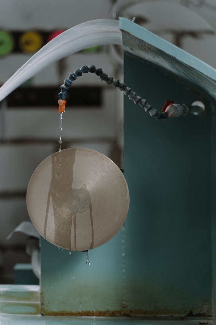 Close-up of a machine tool with liquid cooling system in operation.